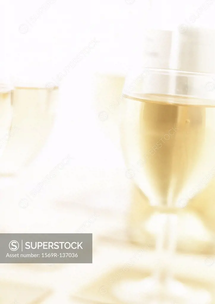 Glasses of white wine, blurred