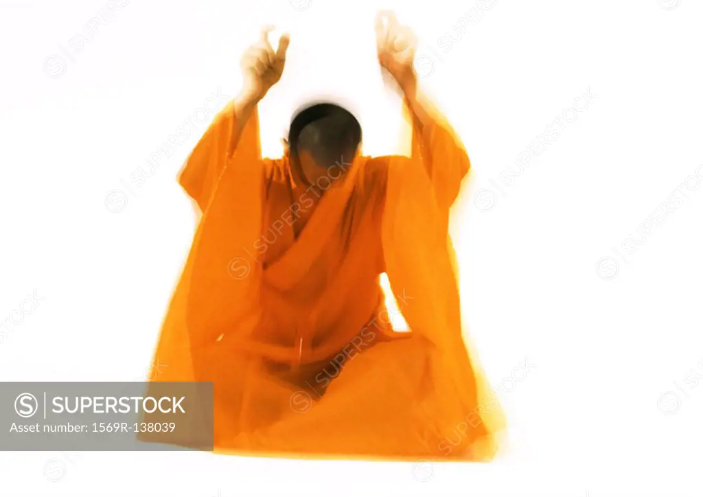 Buddhist monk meditating, blurred motion