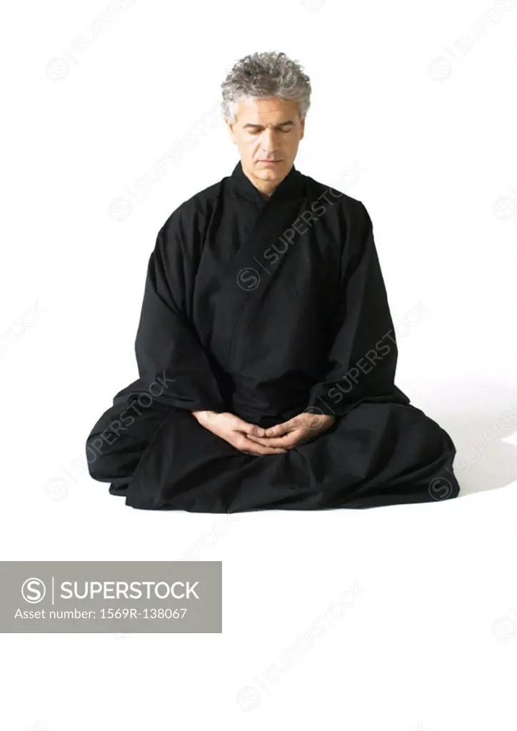 Man sitting on floor, meditating