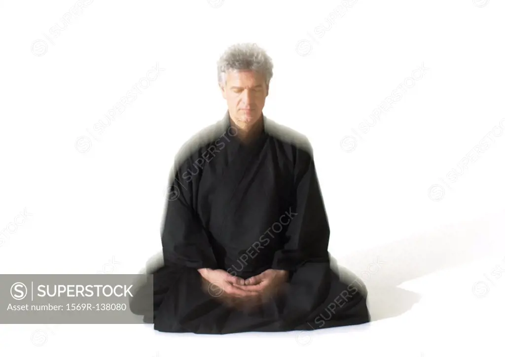 Man sitting indian style, meditating