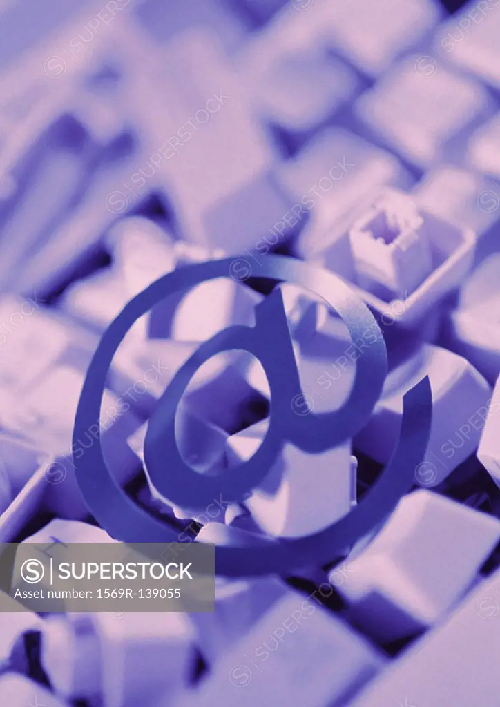 ´@´ symbol on pile of computer keyboard keys