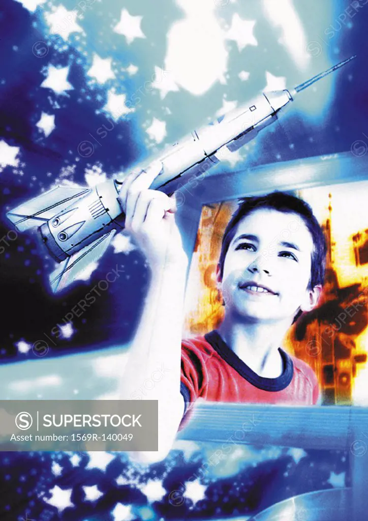 Boy emerging from computer screen, holding space rocket, digital composite