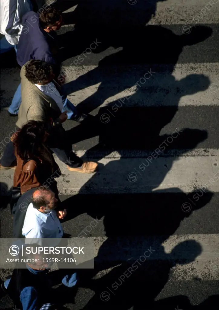 Group of people standing on crosswalk, high angle view