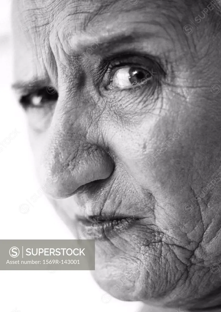 Elderly woman raising eyebrow, looking at camera, portrait, close-up, b&w