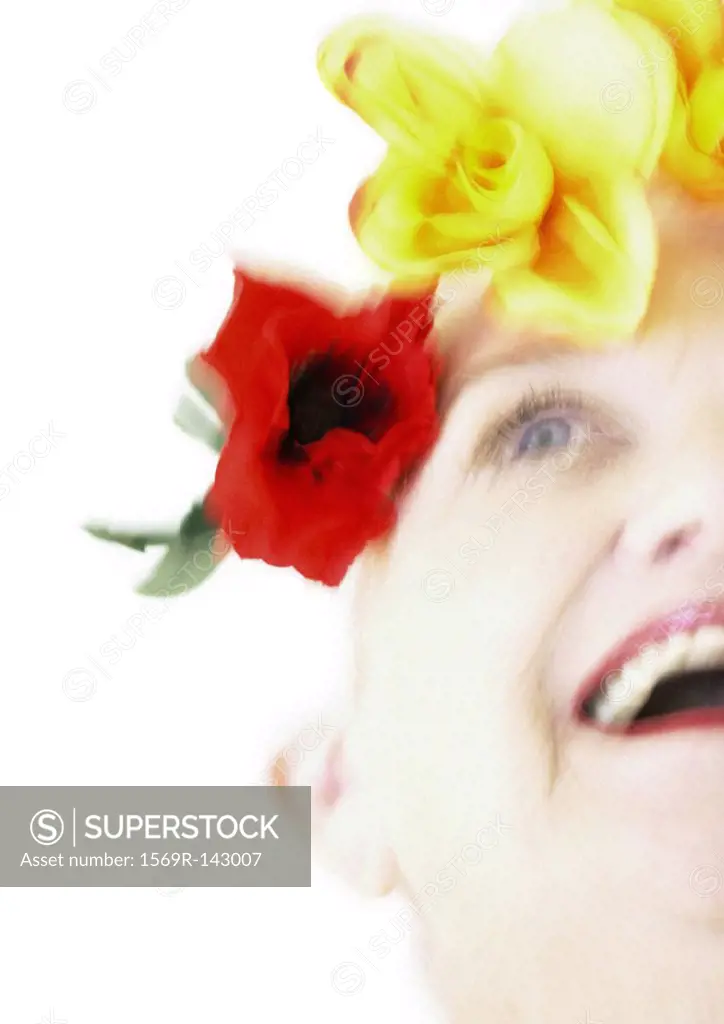 Elderly woman with flowers on head, low angle view, blurred