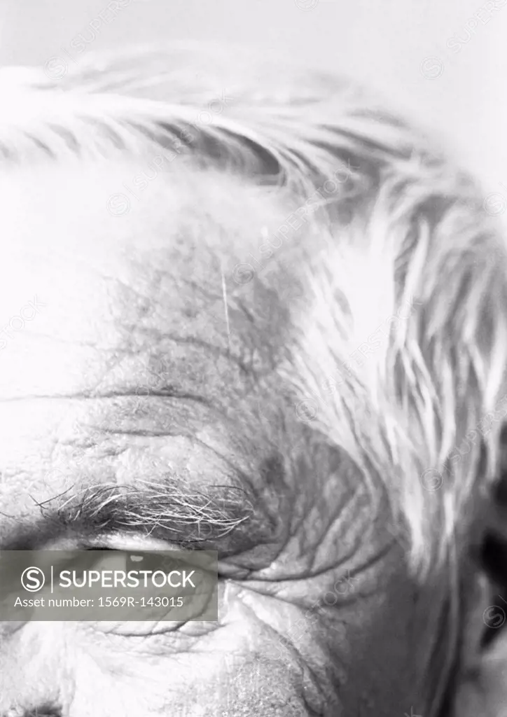 Elderly man looking at camera, partial view, close-up, b&w