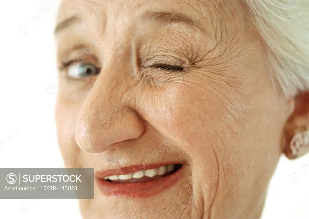 Senior woman winking at camera, portrait, close-up