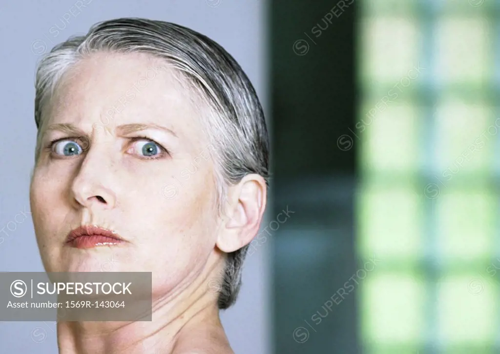 Mature woman looking at camera, close-up, portrait