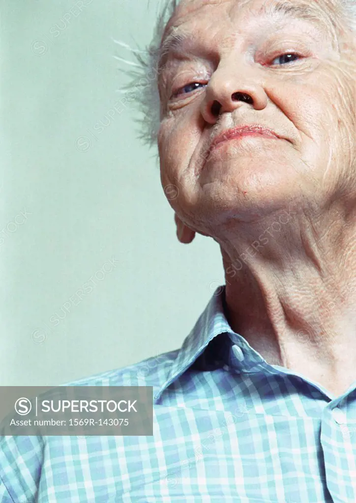 Elderly man looking at camera, low angle view, portrait