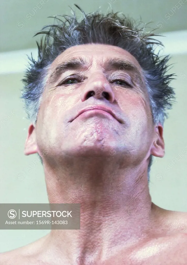 Mature man looking at camera, low angle view, portrait