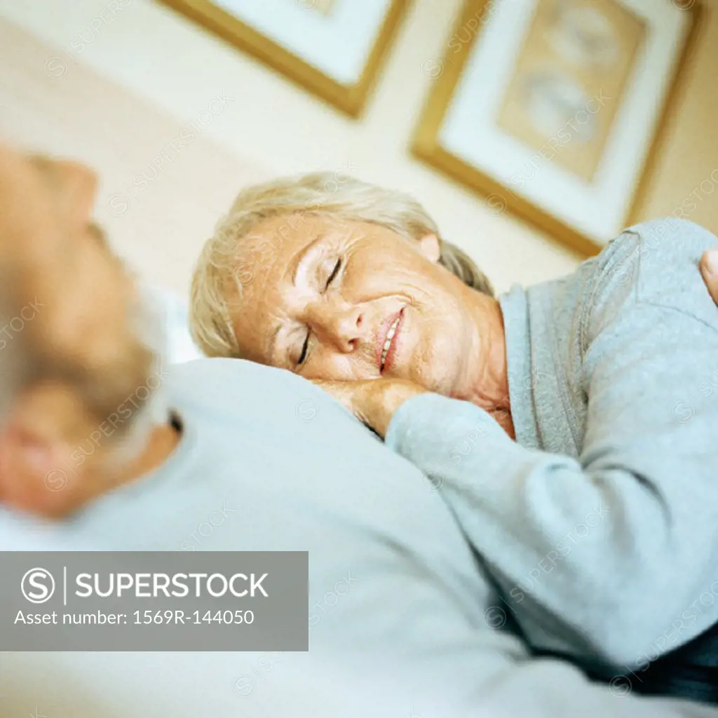 Mature woman leaning on man
