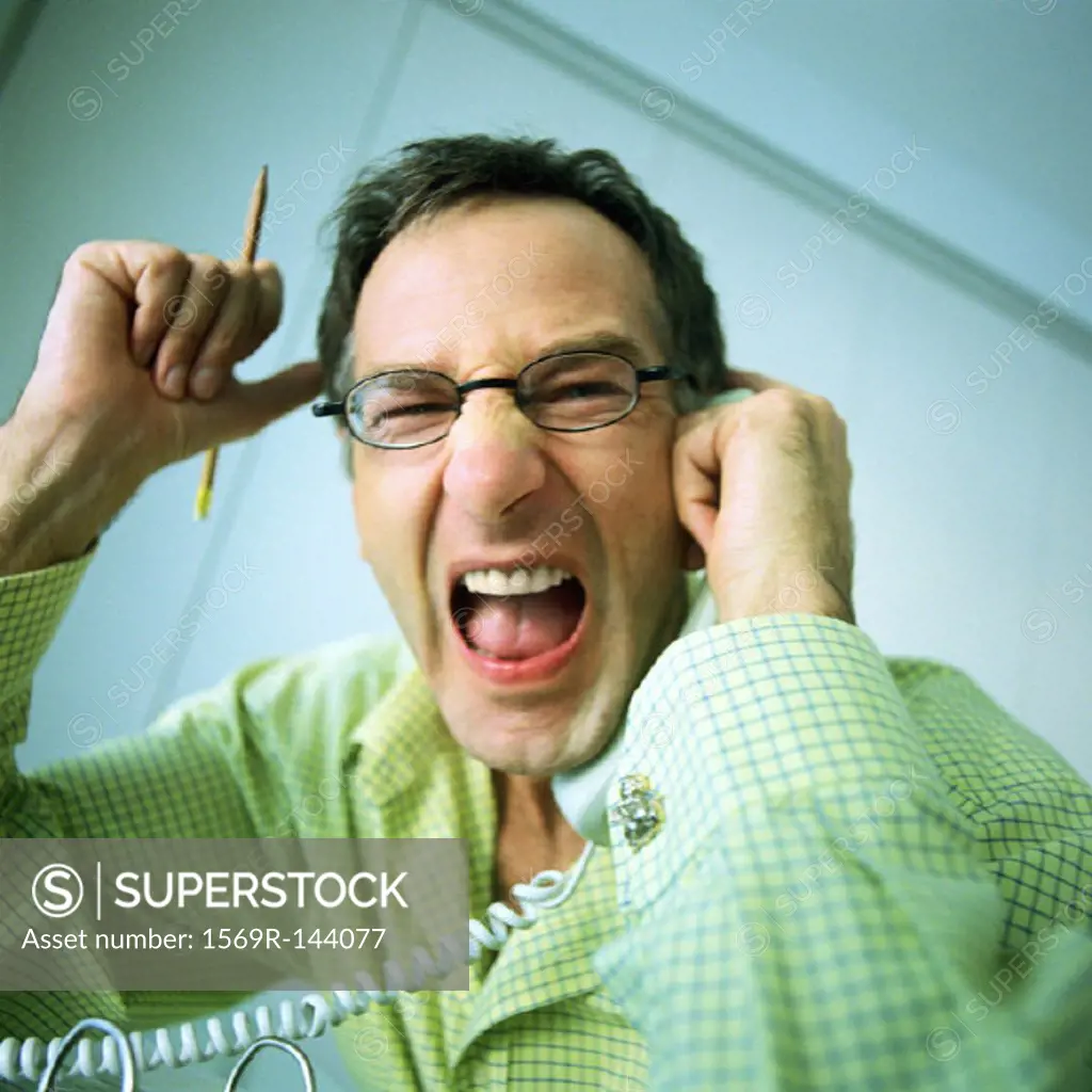 Man holding phone, shouting, portrait
