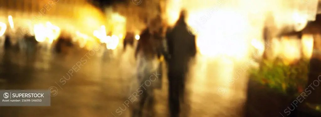 Couple walking at night, blurred