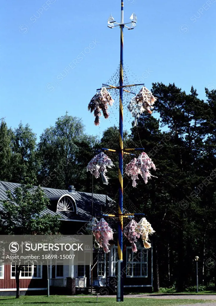 Finland, Maypole in front of red brick building