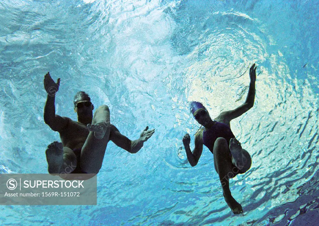Couple swimming underwater, underwater view