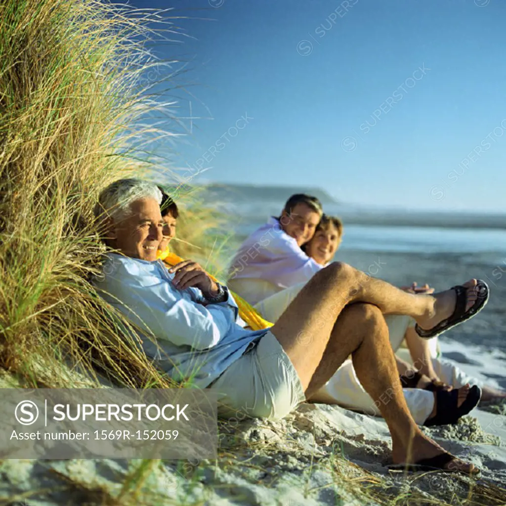 Mature group sitting on beach