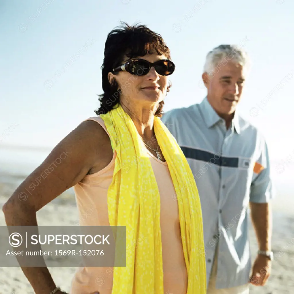 Mature couple standing on beach, portrait