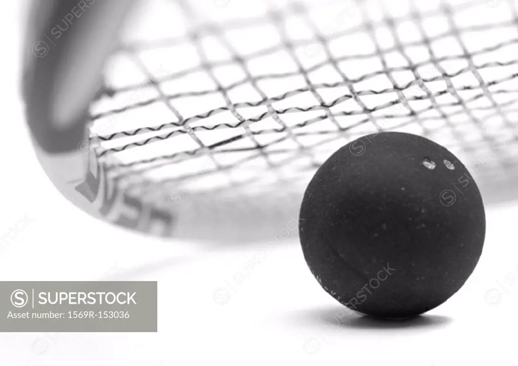 Squash ball and racket, close-up, b&w