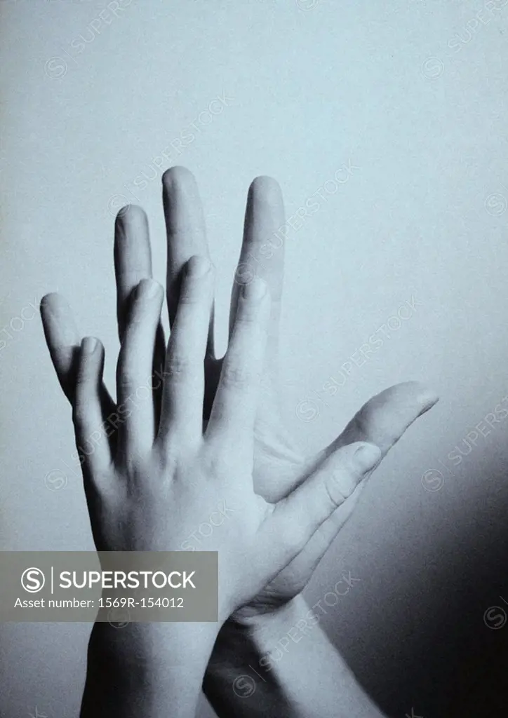 Child´s hand touching man´s hand, palm to palm, close-up, b&w