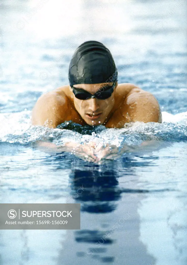 Male athlete swimming breaststroke, close-up