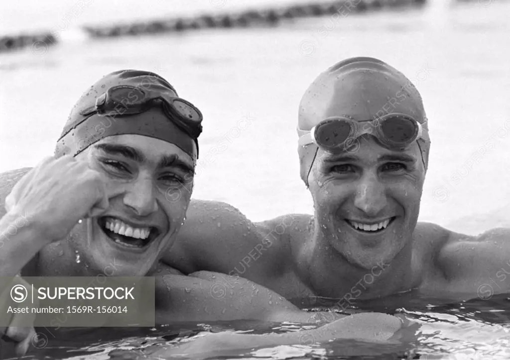 Male swimmers in water, close-up, b&w