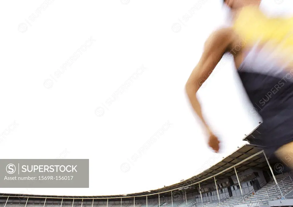 Male athlete running fast, blurred motion