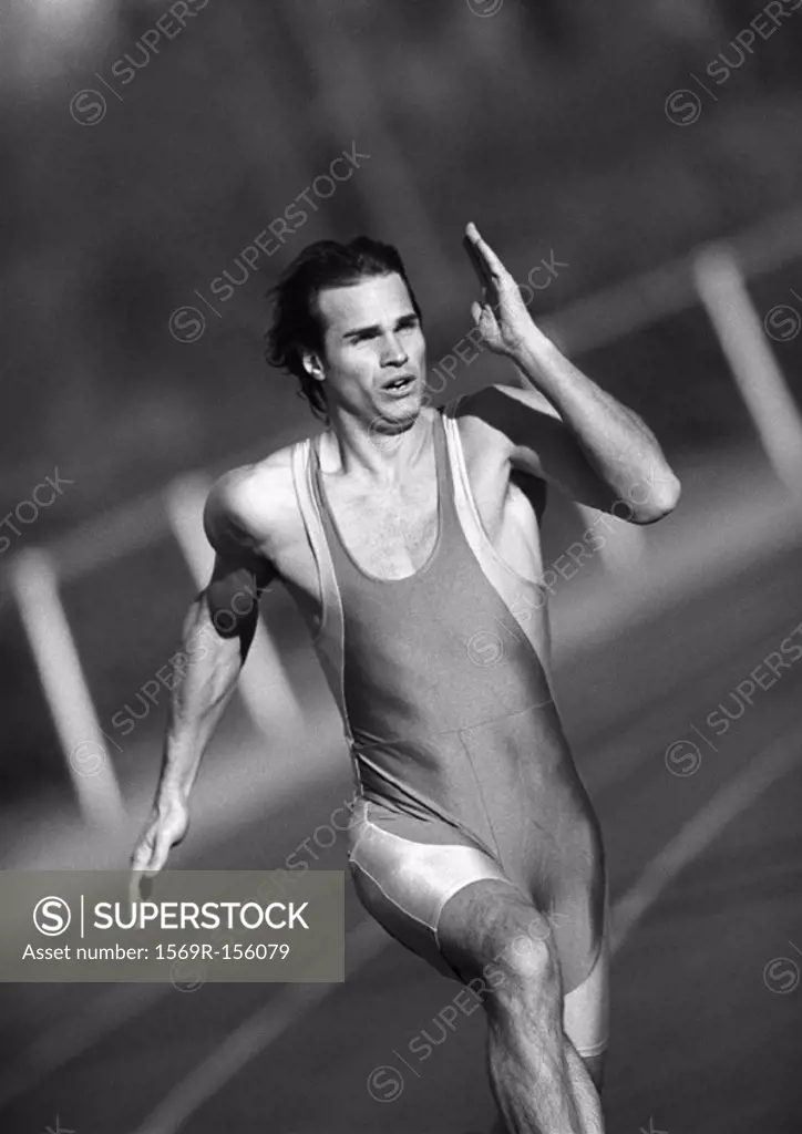 Male athlete running, close-up, b&w
