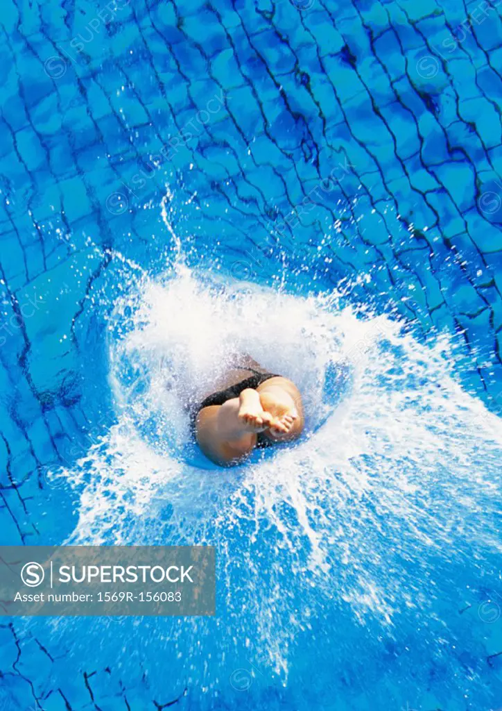Male swimmer diving into pool, overhead view