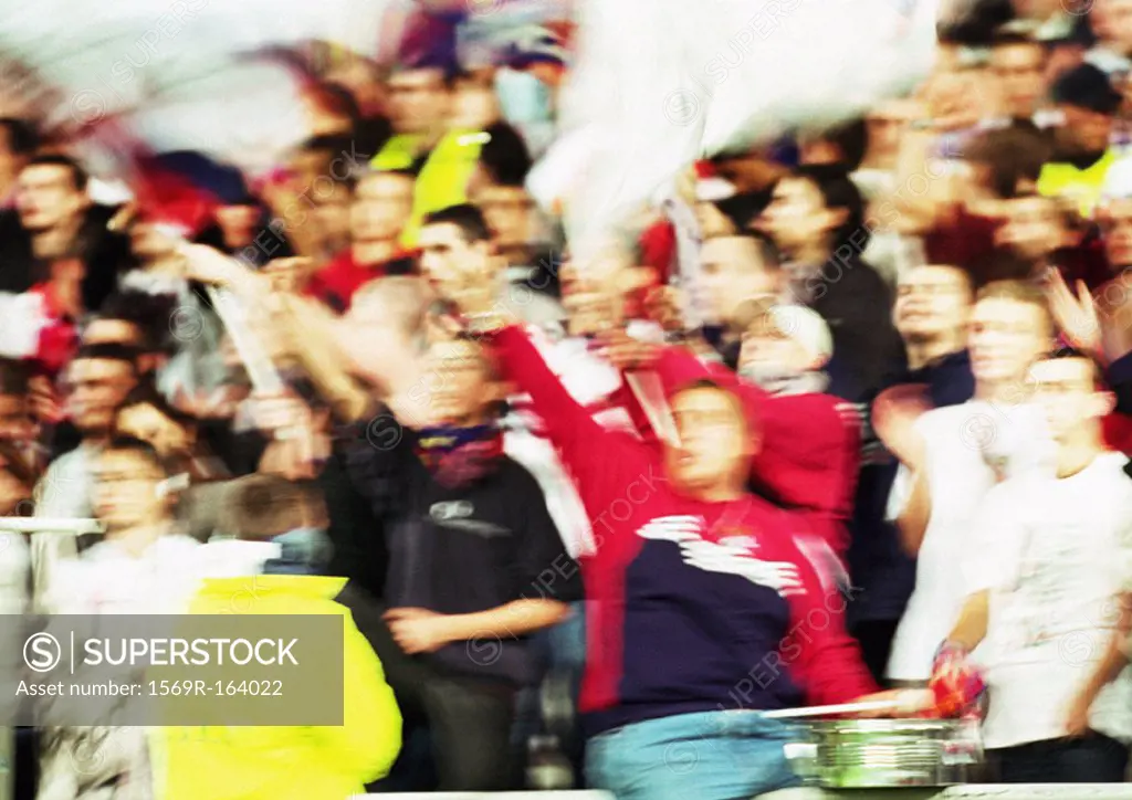 Soccer fans at a match, blurred