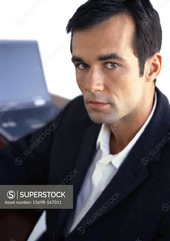 Businessman looking into camera, portrait