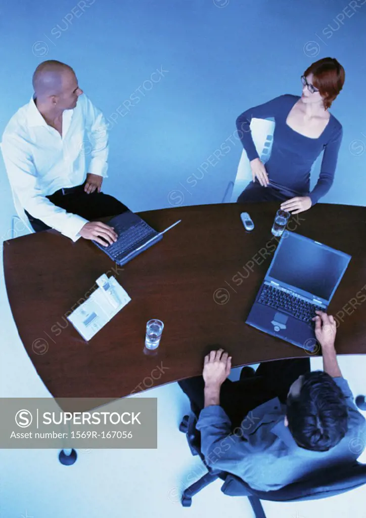 Business people around desk, elevated view