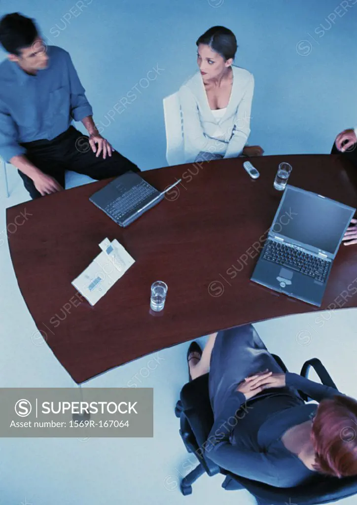 Business people around desk, elevated view