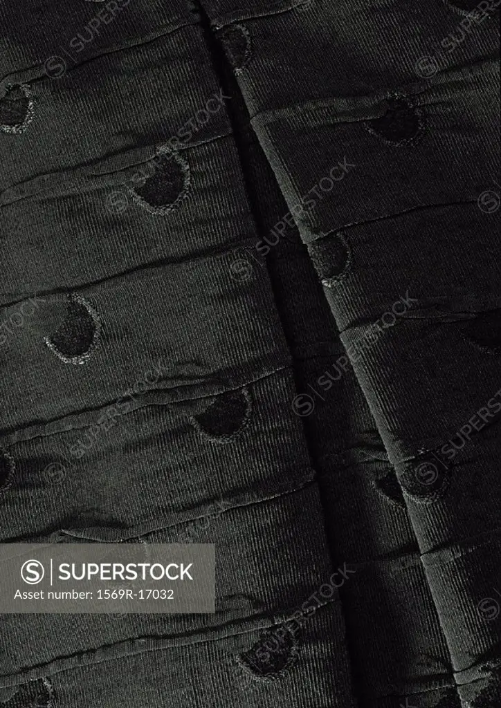 Folds in dark fabric, close-up, full frame