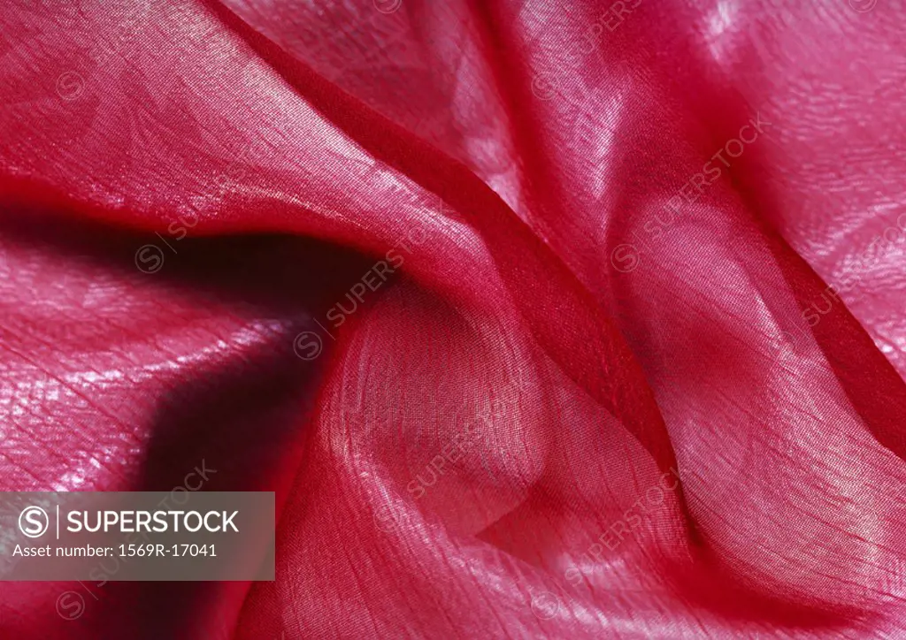 Folds in pink fabric, close-up, full frame