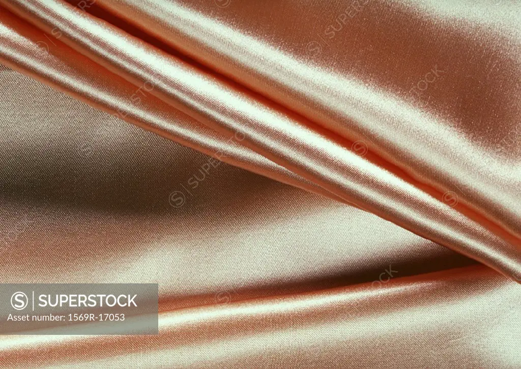 Folds in silky fabric, close-up, full frame