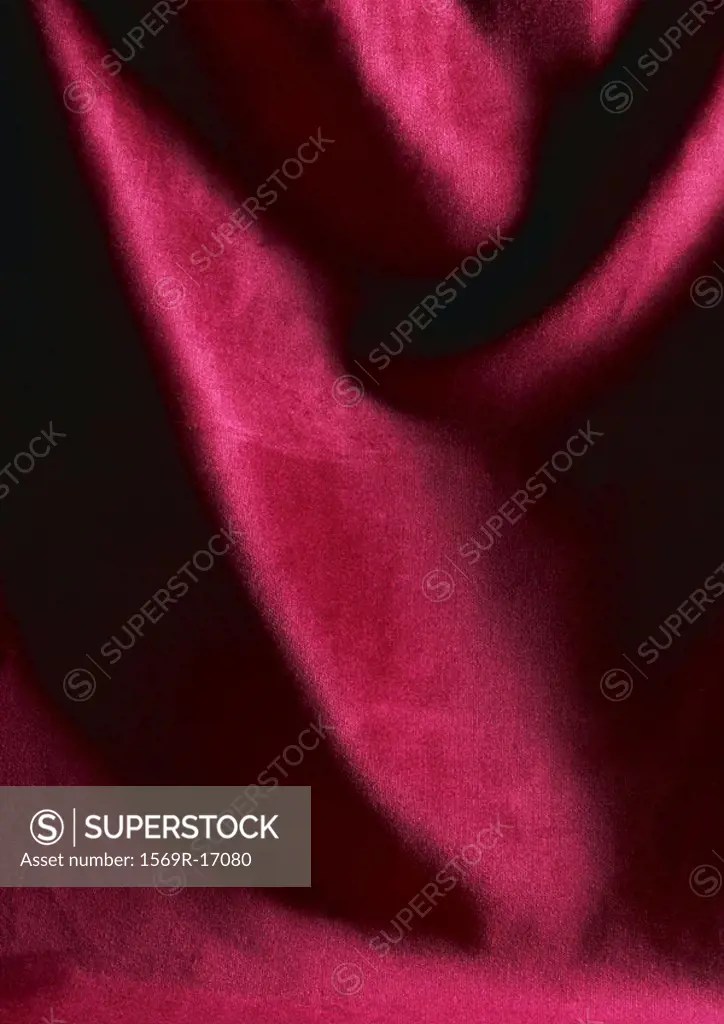 Folds in red fabric, close-up, full frame