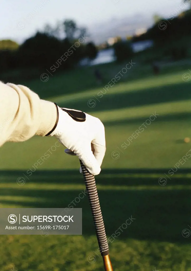 Hand on golf club, close-up