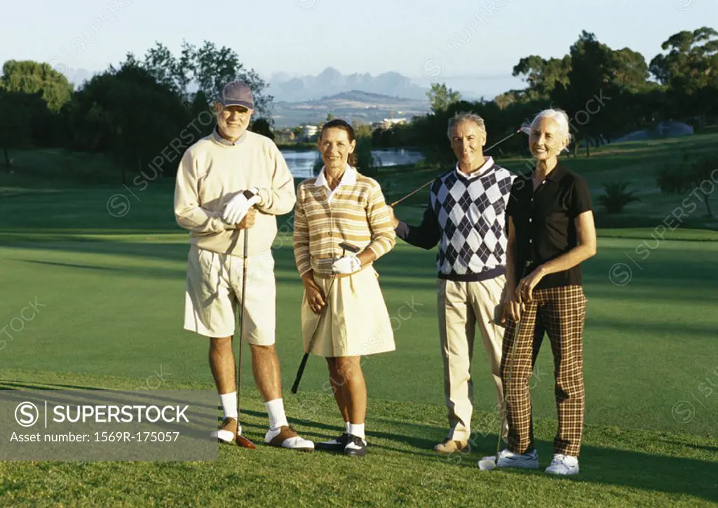 Four mature golfers on green, portrait