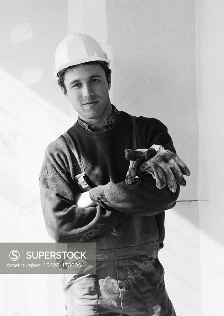 Construction worker wearing hard hat, portrait, b&w