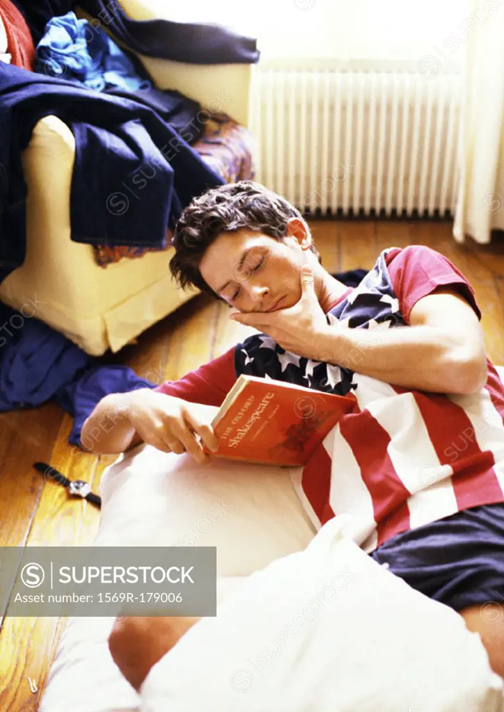 Man reading book on bed