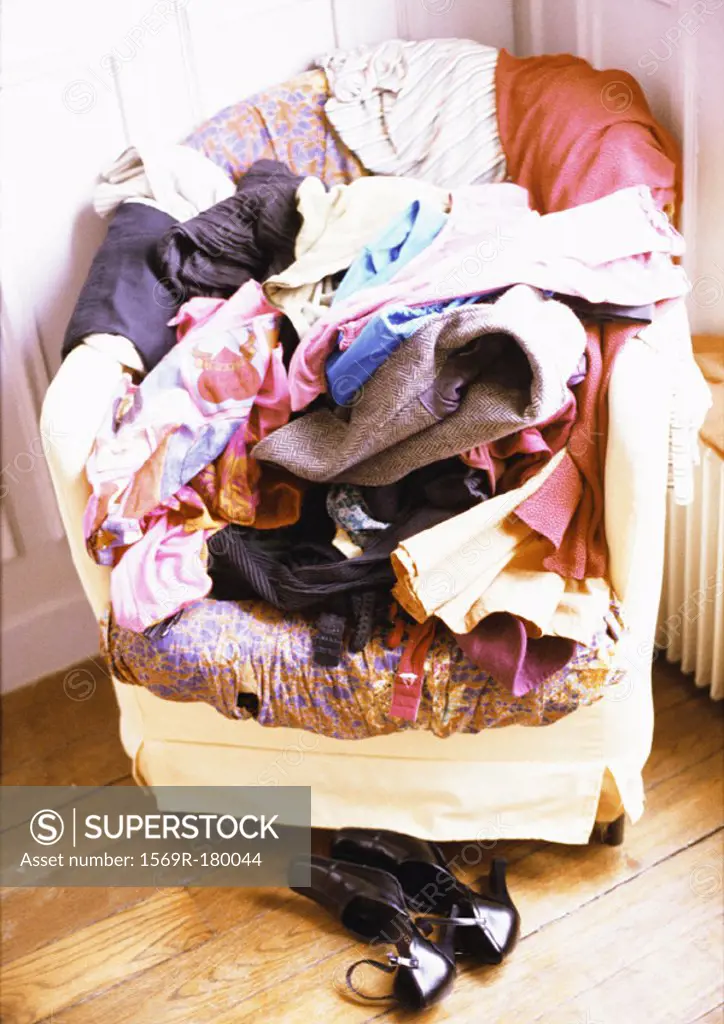 Clothes piled up on armchair