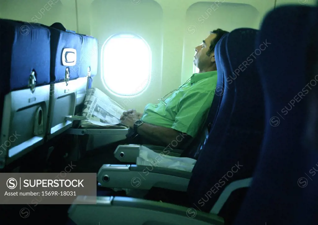 Man sleeping on plane