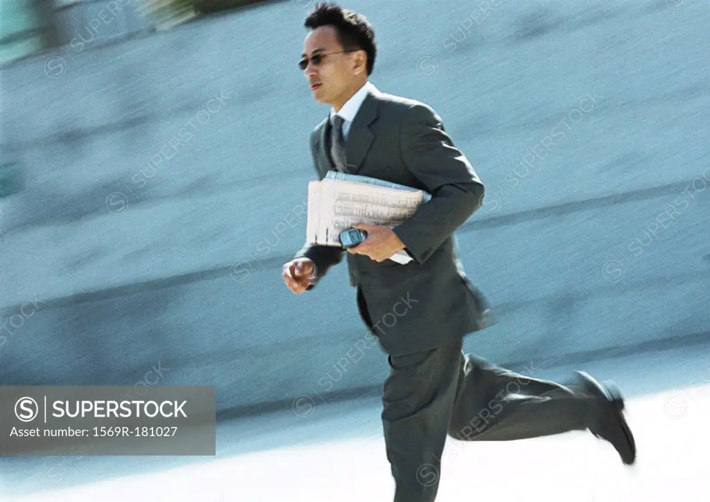 Businessman running outdoors