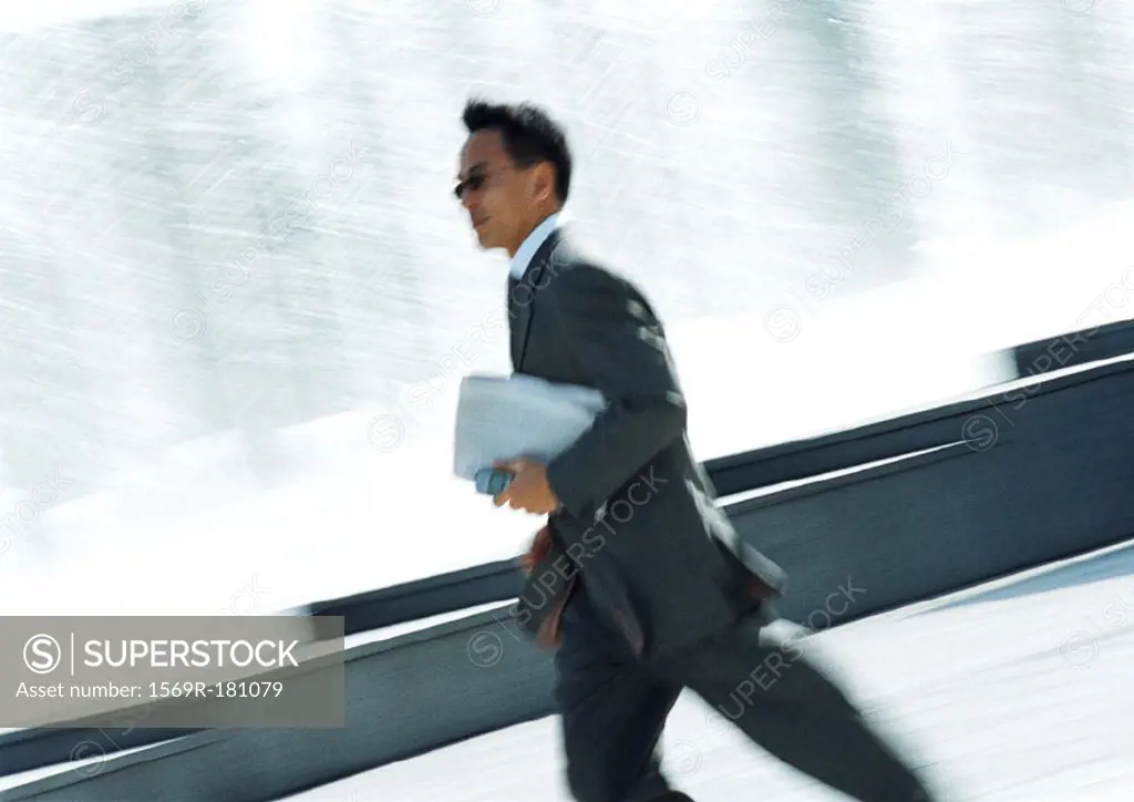 Businessman hurrying with cell phone in hand