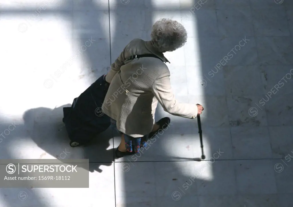 Woman walking with cane, view from above
