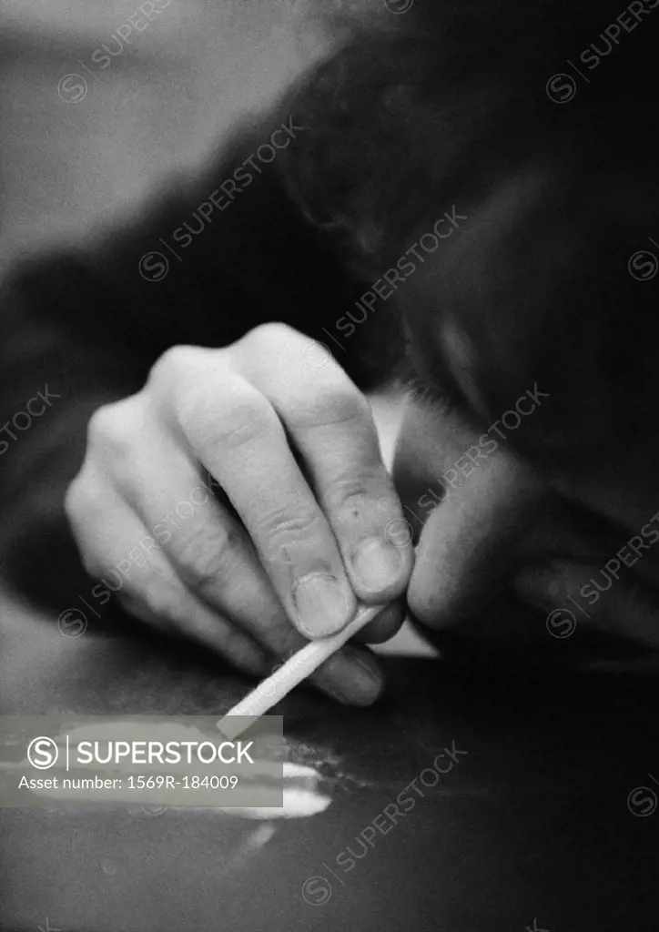 Woman taking drugs, close-up, b&w
