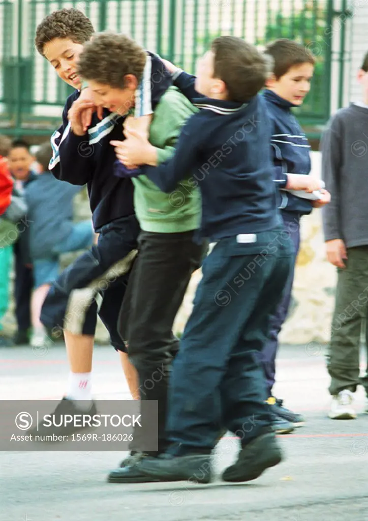 Children playfighting in schoolyard