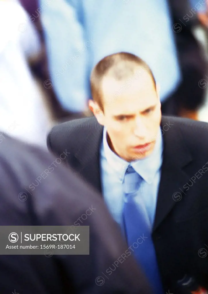 Businessman in crowd, close-up, elevated view