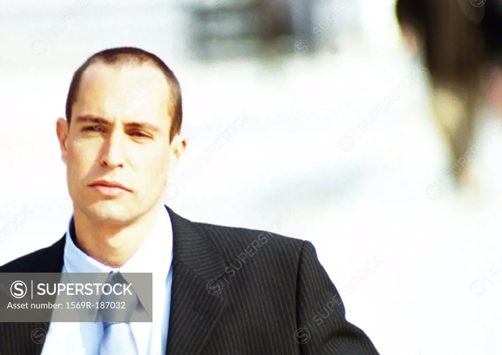 Businessman, head and shoulders, close-up, off center