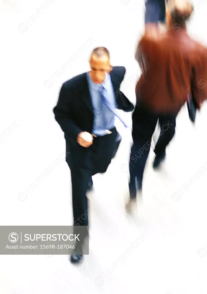 Businessman walking, elevated view, blurred